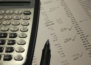 Calculator, pen and paperwork