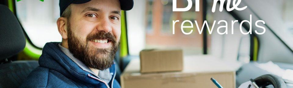 photo of a man smiling towards you whilst holding a checklist whilst he sits in his car. BP me rewards is written on the screen