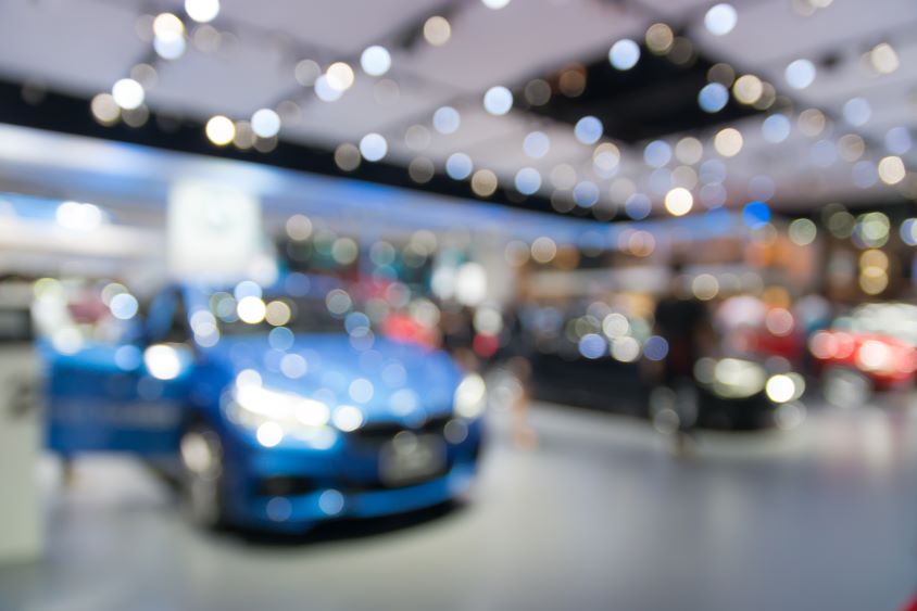 Blurry image of vehicles in a convention showroom