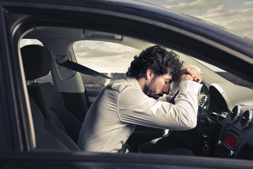 Man in car asleep at the wheel