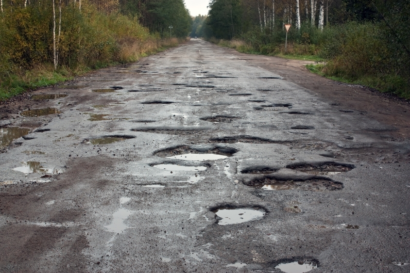 Long road covered in potholes