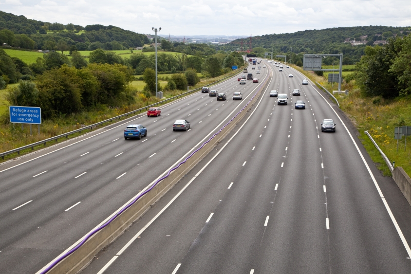 Aerial shot of a smart motorway with four lanes open on each side