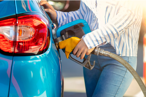 Person filling up car with fuel