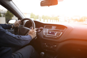 Driving a car with closeup of dashboard