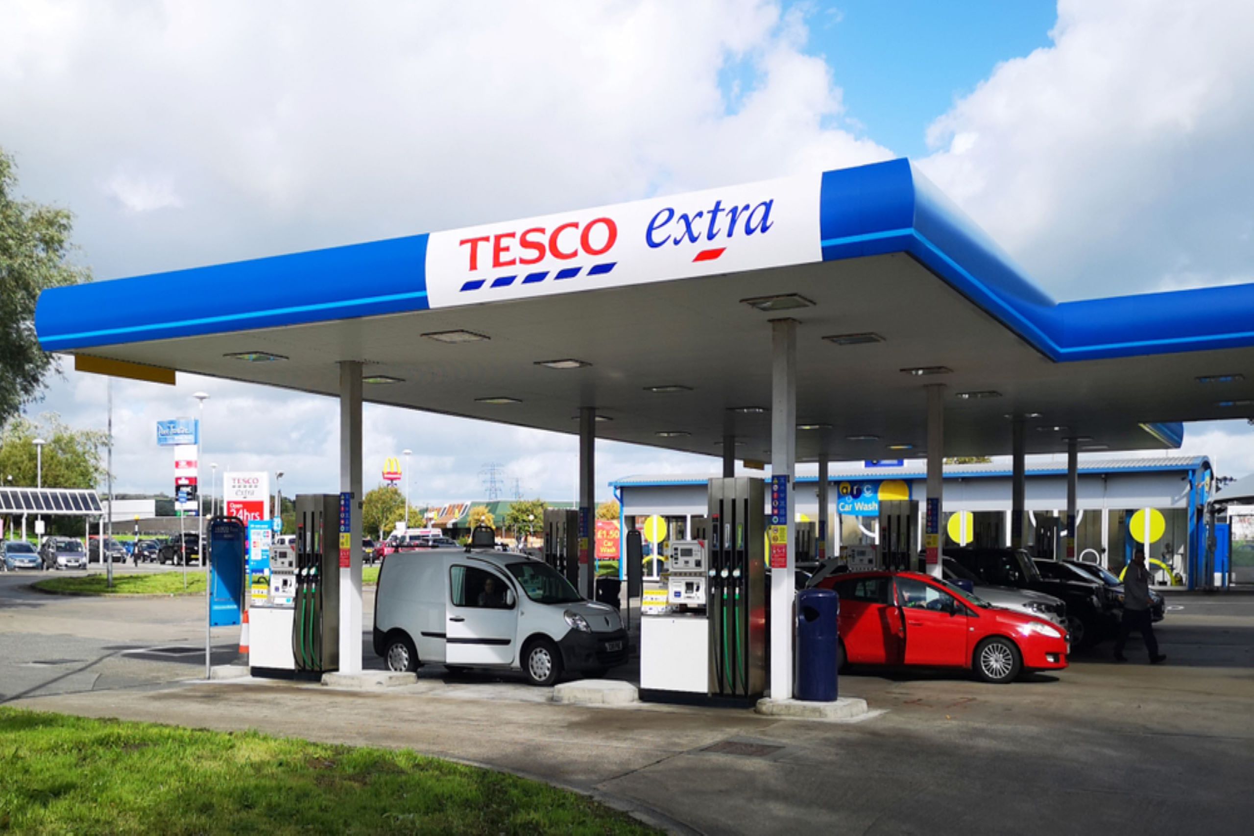 Photo of a Tesco Extra petrol forecourt with customers refuelling