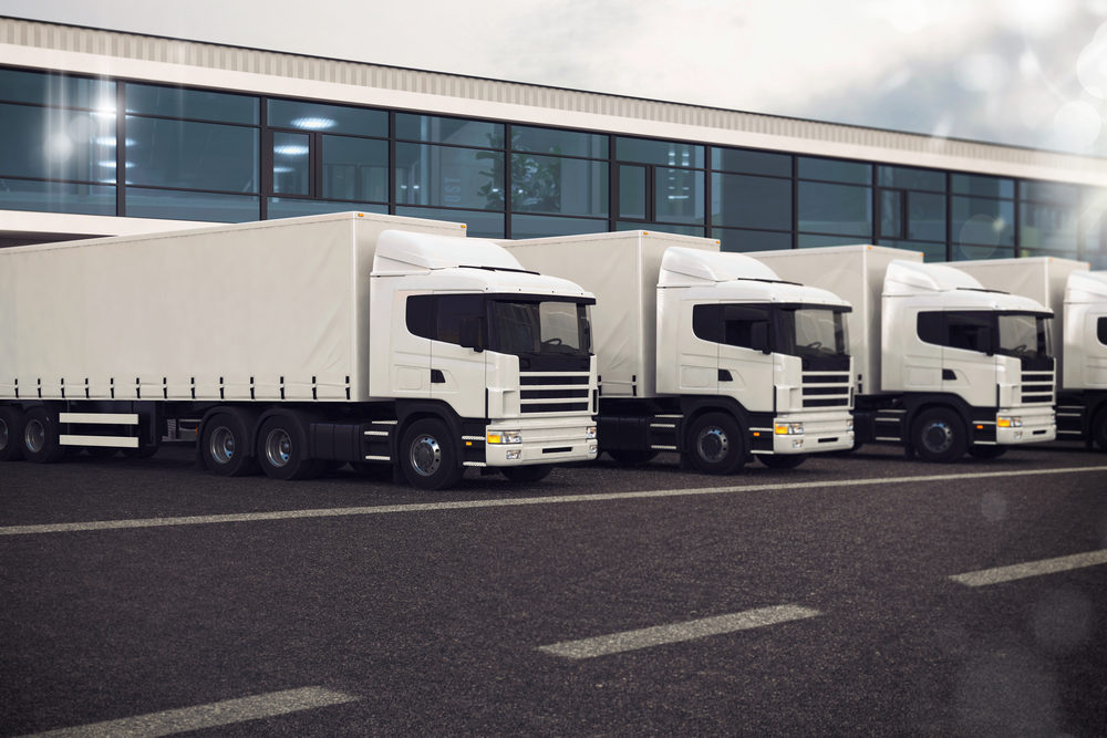 Fleet of parked HGVs with trailers