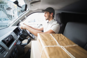 Van driver making delivery with parcels on seat