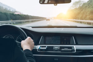 Dashboard view of person driving a car down motorway