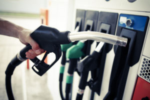 Close up of hand holding a fuel pump at filling station