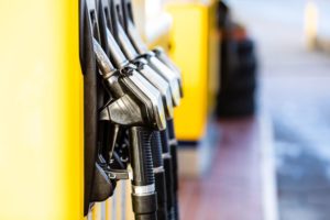 Fuel nozzles lined up at yellow fuel pumps