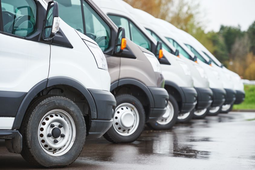 Close-up of a row of parked commercial vans