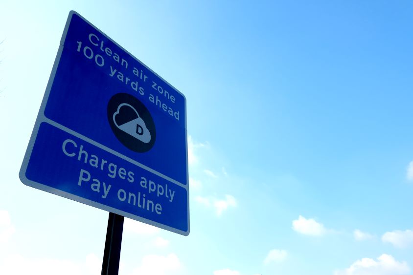 A Clean Air Zone Road sign on a street in the UK