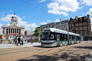 A tram passing the City Hall in Nottingham, UK