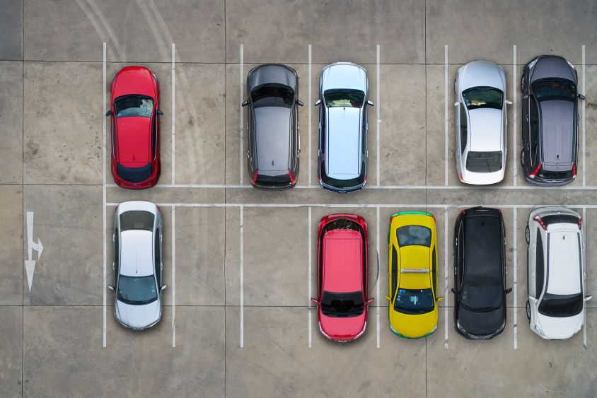 An aerial view of cars in parking spaces