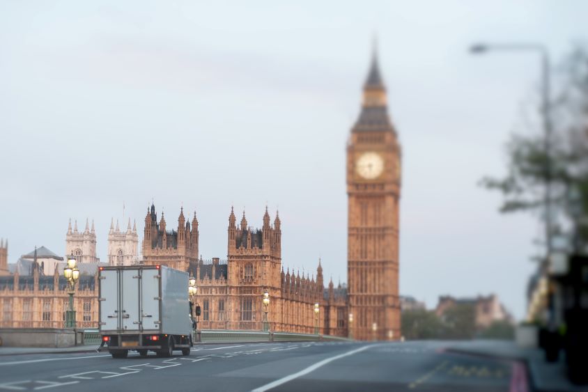 Lorry driving over bridge towards Big Ben, London