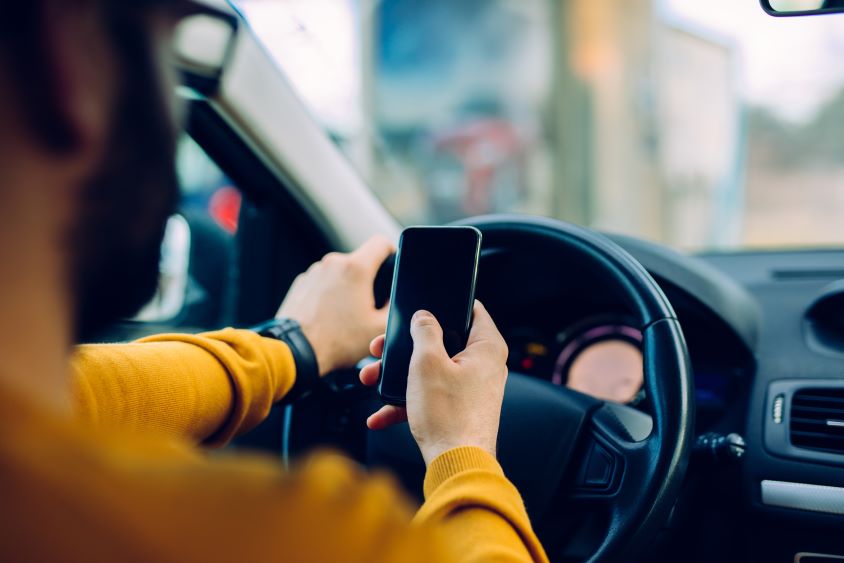 Man using phone whilst driving