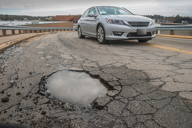 Car avoids large pothole which could cause vehicle damage