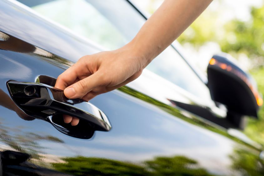 Hand on car door handle