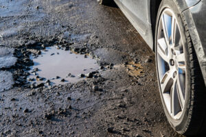 Car wheel avoiding small pothole