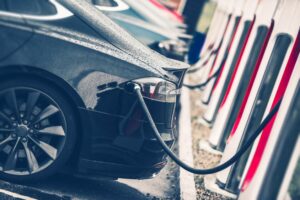 Row of electric cars connected to charging points