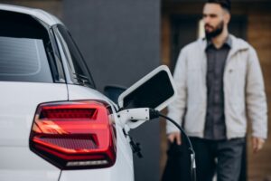 Man charging an electric car